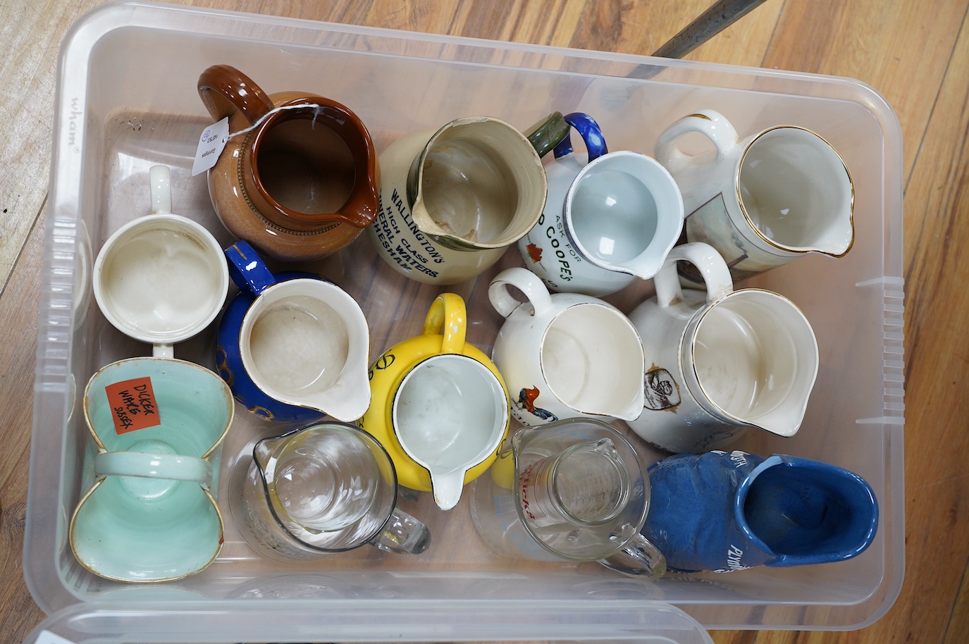 Twenty ceramic jugs, etc. most with advertising for breweries, marked for measures, etc. including a Bass brewery glass panel, pre-decimal framed price list, etc. Condition - varies, some chipping